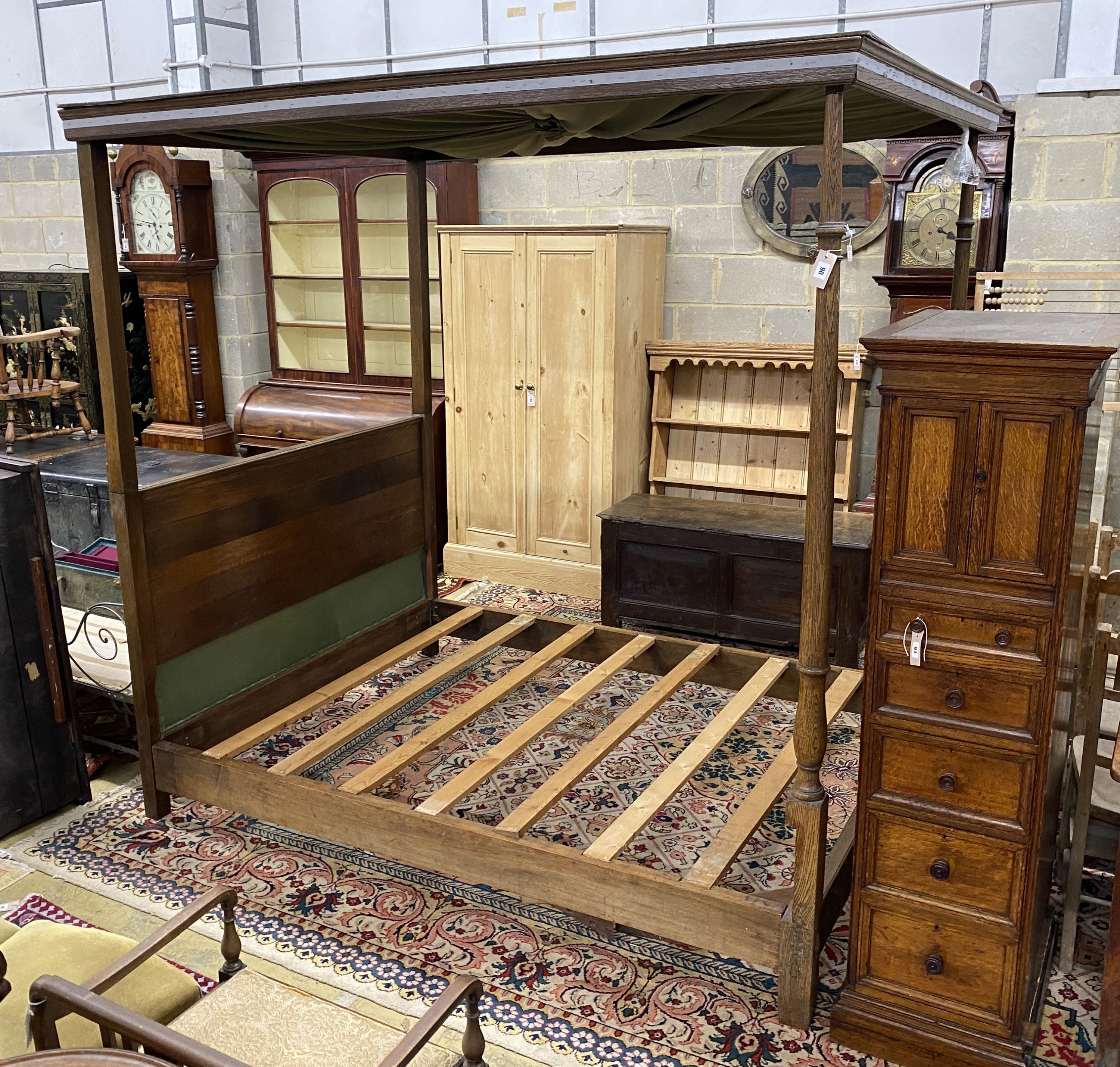 A George III style oak four poster bed frame, with drapes, length 205cm, width 152cm